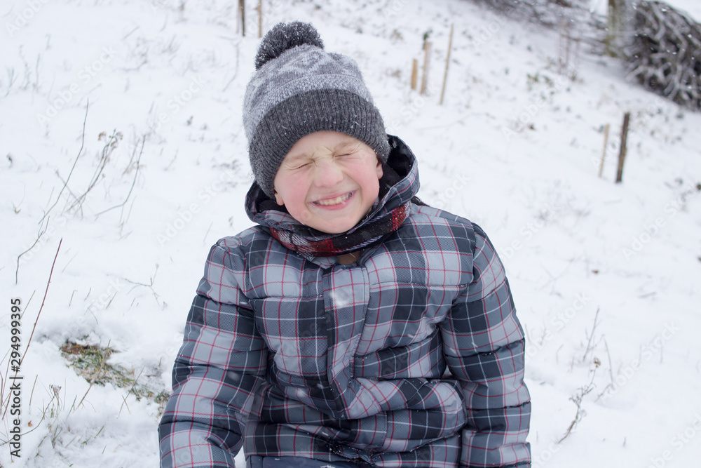 winter boy laughs,happy boy laughs in winter with his eyes closed winter boy laughs,happy boy laughs in winter with his eyes closed