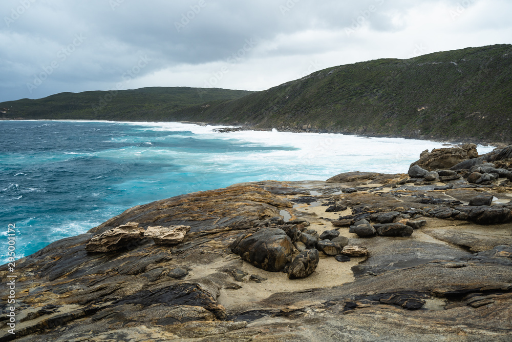 The Natural Gap, Albany, Western Australia. Dramatic and moody landscape with large rough waves breaking on the rocks. 
