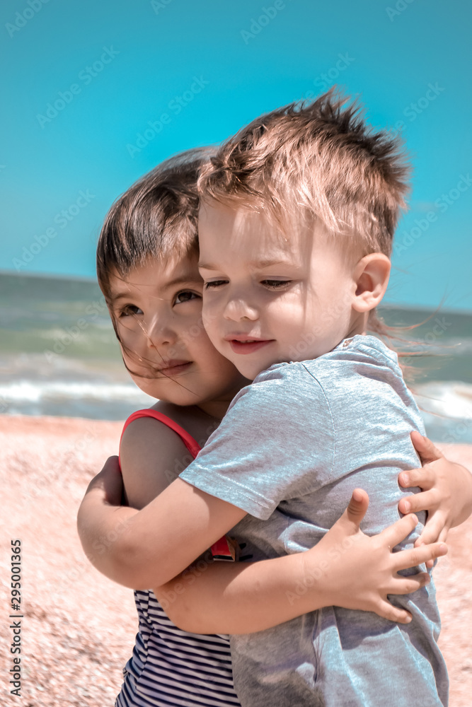Charming kids on the sandy beach of the southern coast of Crimea Charming kids on the sandy beach of the southern coast of Crimea