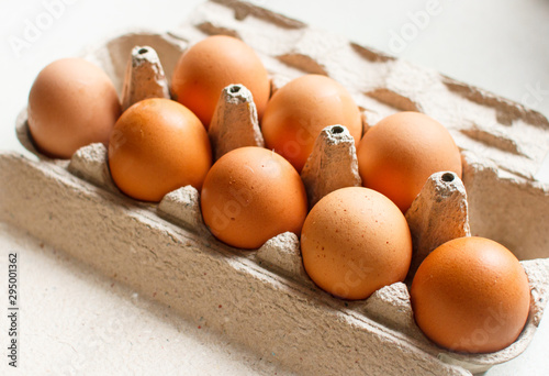 The brown eggs in egg box.