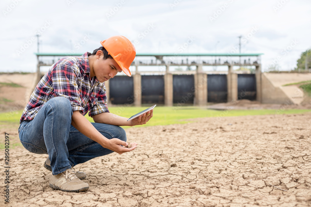 Young engineer working on site at the dam Young engineer working on site at the dam