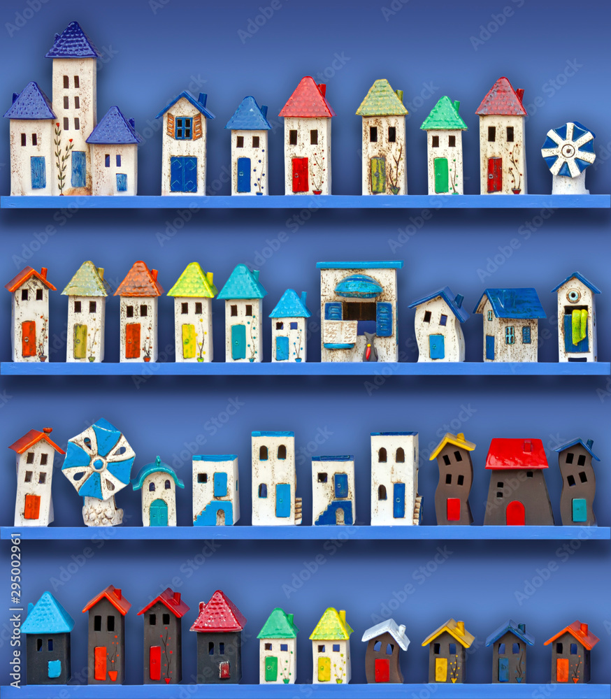 colorful ceramic houses made by hand,  on blue background