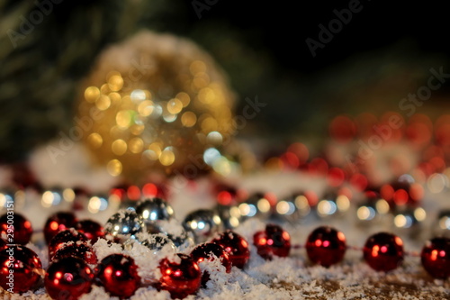 beautiful Christmas photo with twigs of spruce, Christmas toys on the background of falling snow