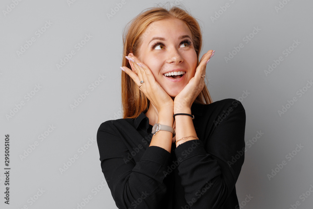 Image of thinking young woman standing over a gray background. Image of thinking young woman standing over a gray background.
