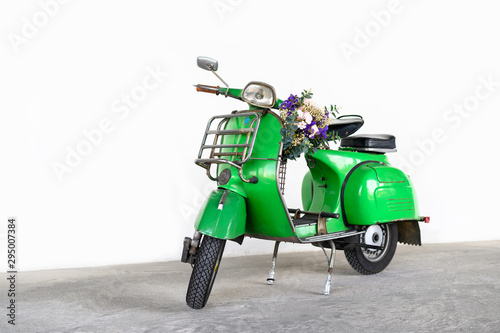 Canvas Print Green vintage scooter with a bouquet of flowers in basket