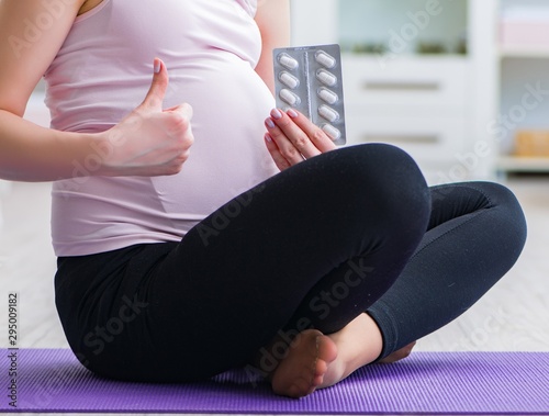 Pregnant woman exercising in anticipation of child birth