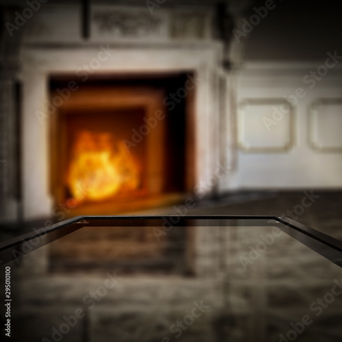 Glass table top with blurred fireplace and home interior background. Empty space background for your products and decoration.  