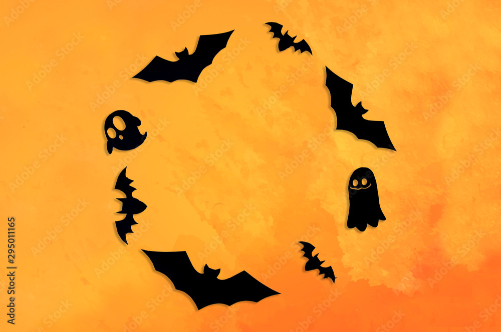Bats cut out of black paper, ghosts on an orange background. Greeting card, background, banner for the holiday Halloween. Bats cut out of black paper, ghosts on an orange background. Greeting card, background, banner for the holiday Halloween.