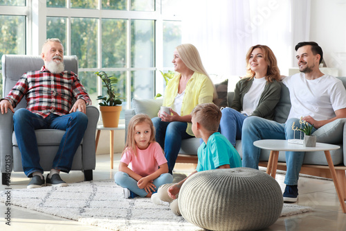 Big family watching TV toge...