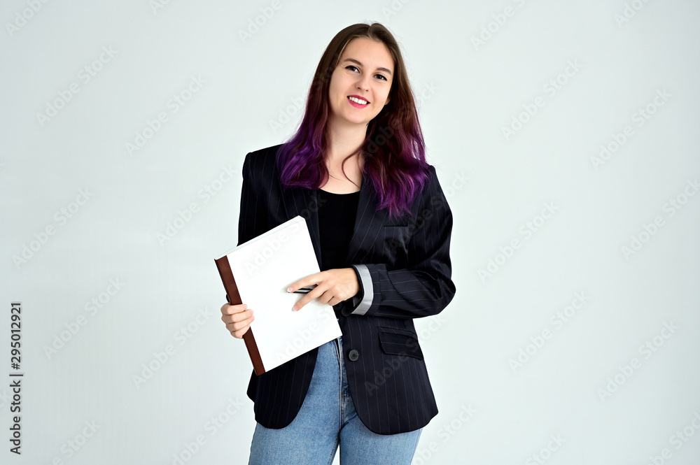 Studio portrait of a pretty brunette student girl with long hair in a jacket on a white background. Smiling at camera with emotions in various poses. Studio portrait of a pretty brunette student girl with long hair in a jacket on a white background. Smiling at camera with emotions in various poses.