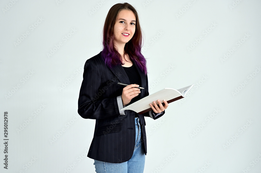Studio portrait of a pretty brunette student girl with long hair in a jacket on a white background. Smiling at camera with emotions in various poses. Studio portrait of a pretty brunette student girl with long hair in a jacket on a white background. Smiling at camera with emotions in various poses.