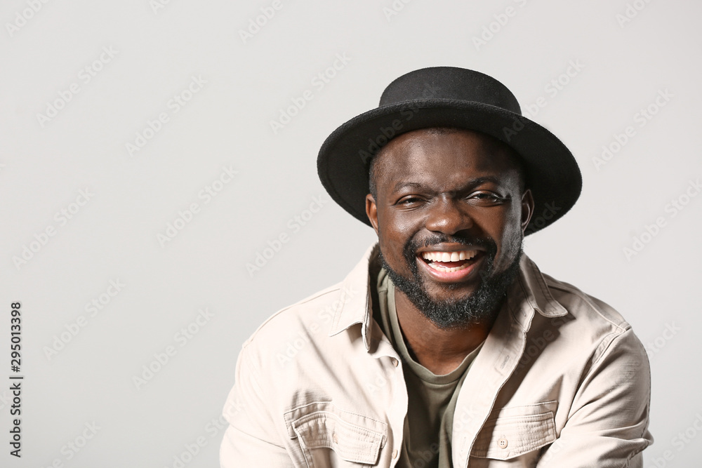 Portrait of happy African-American man on grey background Portrait of happy African-American man on grey background