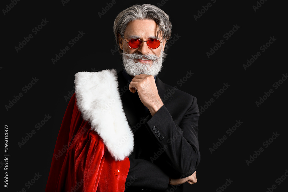 Portrait of stylish Santa Claus on dark background
