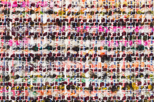 varicoloured woven yarns of boucle fabric close up photo
