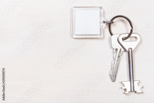 Photography pair of door keys on keyring with blank keychain