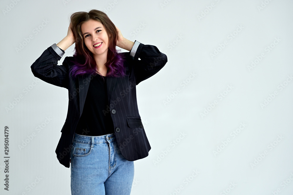 Studio portrait of a pretty brunette student girl with long hair in a jacket on a white background. Smiling at camera with emotions in various poses. Studio portrait of a pretty brunette student girl with long hair in a jacket on a white background. Smiling at camera with emotions in various poses.