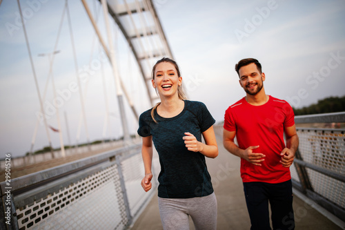 Healthy sporty young people jogging and running outdoors