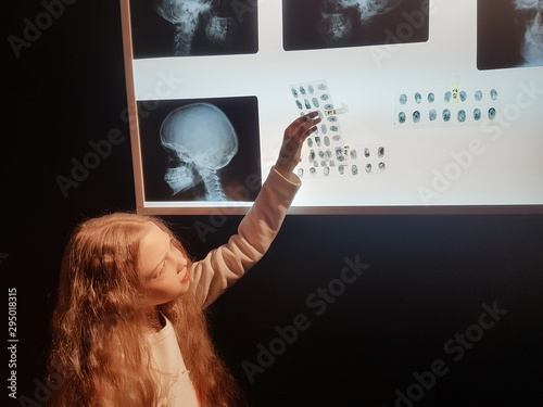 girl detective examining the prints .the concept of a hobby photo