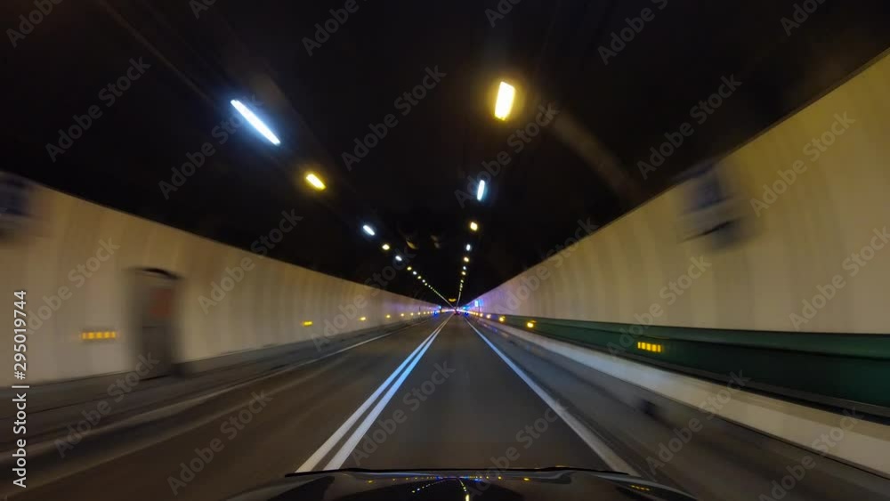 Road trip on Europe, first-person view of a moving car on a highway, ride inside the tunnel under the mountain.