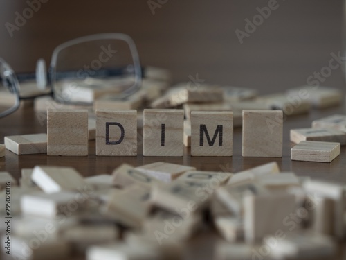 The concept of Dim represented by wooden letter tiles photo