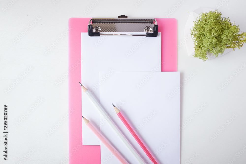 Pink clipboard, paper and group of pencils. Pink clipboard, paper and group of pencils.