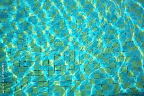 Surface of water and flow with waves in swimming pool background. Relax concept.