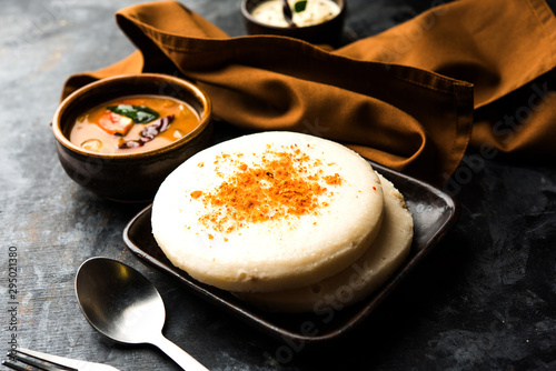 Thatte or Taste Idli also known as Plate Idly is a Popular south Indian Food, served with sambar and chutney.  photo