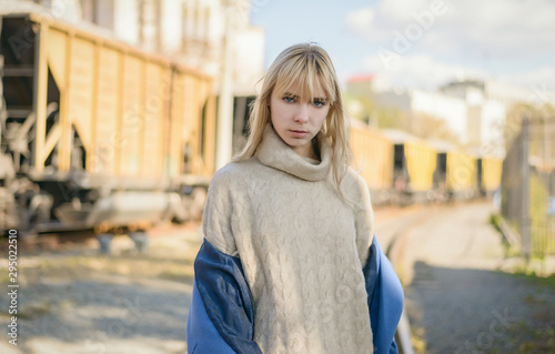 Portrait of young woman wearing blue coat.