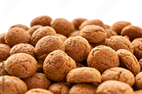 Close-up rows of many dutch ginger nuts candy. Also known as pepernoten or kruidnoten for the Dutch annual children's feast Sinterklaas on the 5th of december. Isolated on top for copy space.