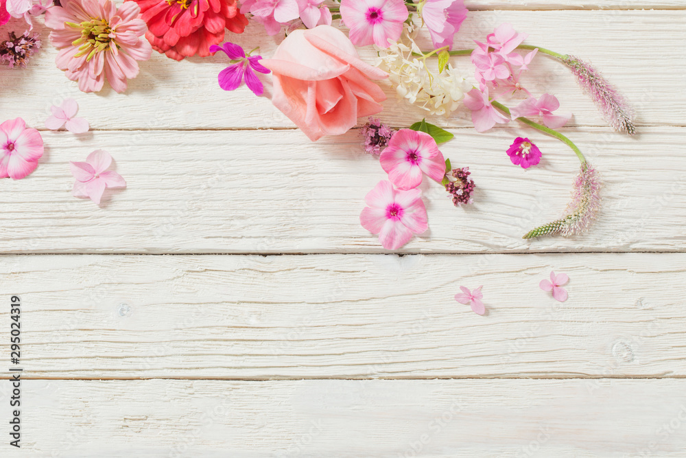 pink flowers on white wooden background pink flowers on white wooden background
