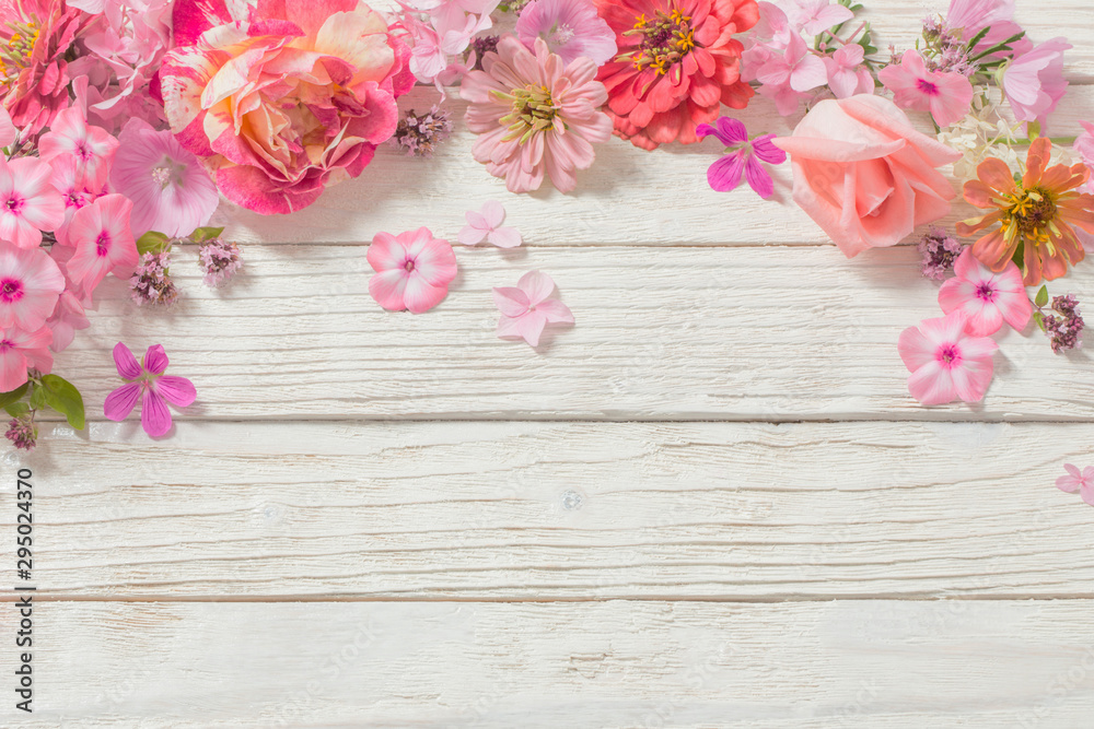 pink flowers on white wooden background