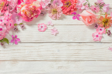 pink flowers on white wooden background