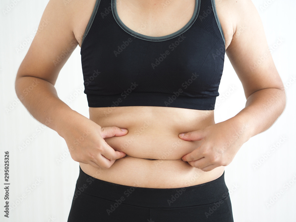 Φωτογραφία cellulite and belly fat in woman, She grabbing her abdomen near waist cause of fatty from weight and loss of collagen use for anti cellulite and body firming gel,cream product or liposuction concept