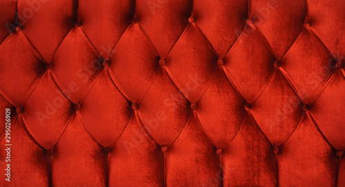 red velvet texture close up red chesterfield sofa pattern velvet as background photo