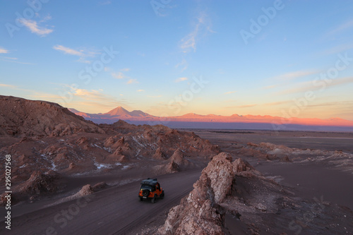 Northern Chile - San Pedro de Atacama and surrounding area - Valle de la Luna or Moon valley - this red rock landscape complete with sand dunes looks like a moon landing at sunset with red orange blue