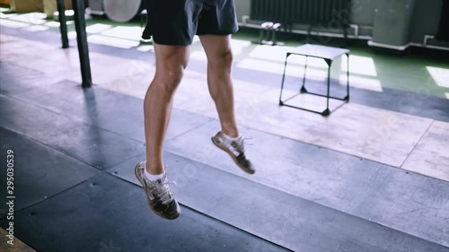 Jumping squats at gym. Effective exercises for a great fit. lunch short workout. Effective powerlifting jumps. Male fitness instructor showing squat exercise at loft plase.