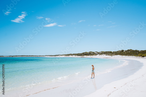 Girl walking along an empty beach alone, enjoying her alone time. Hangover Bay, Perth, Western Australia photo