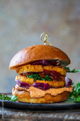 Vegan pumpkin burger with harrisa hummus and chicory photo