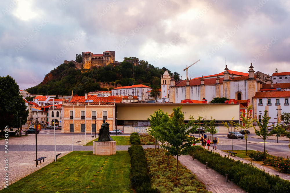 View of the city and castle in Leiria, Portugal in the evening. Cloudy sky