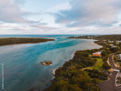 The river meeting the sea in Augusta, Southern Australia. Beautiful sunset over the vibrant blue water.  photo