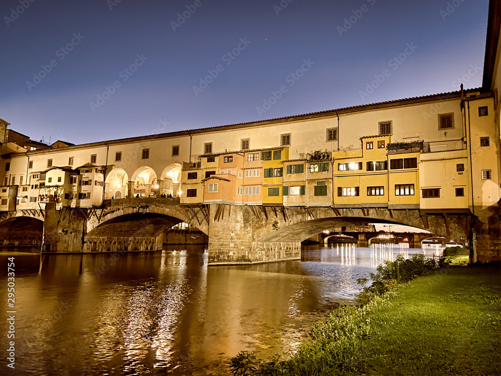 Old Bridge and Florence Lungarni at night. Panoramic cityscape in Autumn, Tuscany - Italy