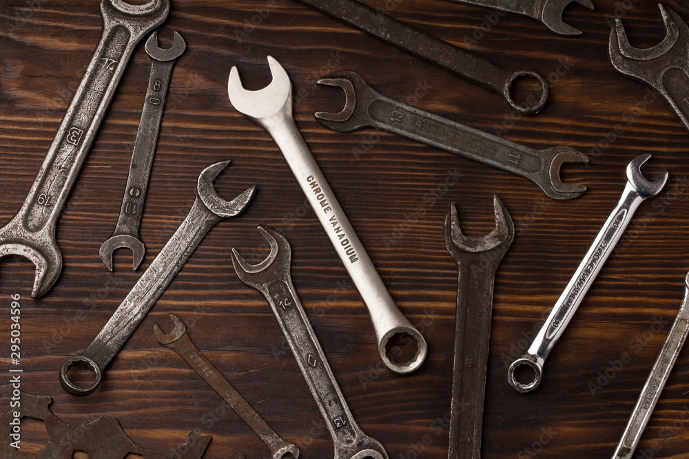 open end wrench set over the dark wood table. Hand tool. Instrument. Close-up. labor Day concept open end wrench set over the dark wood table. Hand tool. Instrument. Close-up. labor Day concept