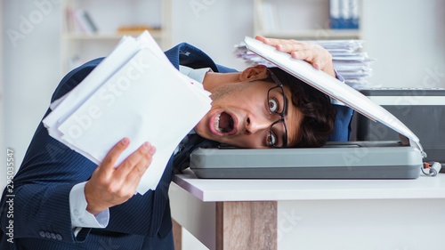 Businessman making copies in copying machine