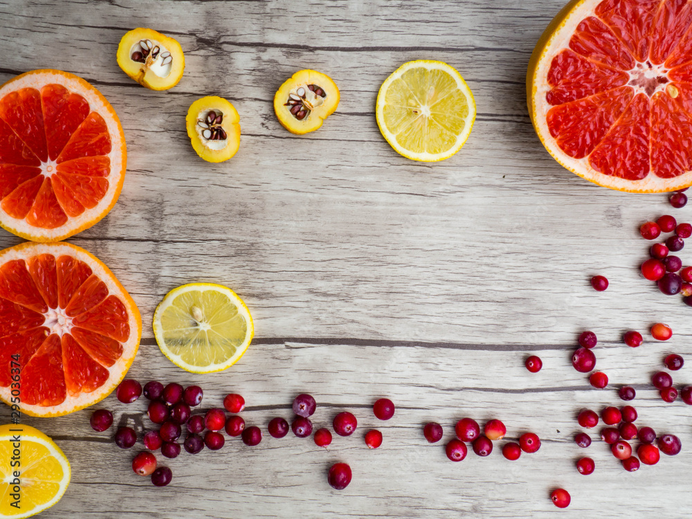 grapefruits, lemon, cydonia slices, red cranberries, top view. Natural vitamins and antioxidants food concept. grapefruits, lemon, cydonia slices, red cranberries, top view. Natural vitamins and antioxidants food concept.