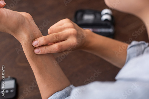 cropped view of woman checking pulse at home