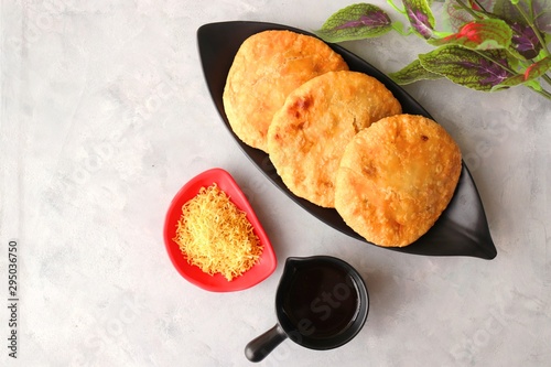 Shegaon or Rajasthani Kachori served with tamarind Chutney and sev.  Kachori or Kachodi is a spicy fried snack from India stuffed with spicy potatoes and onion mixture. photo