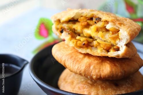 Shegaon or Rajasthani Kachori served with tamarind Chutney and sev.  Kachori or Kachodi is a spicy fried snack from India stuffed with spicy potatoes and onion mixture.