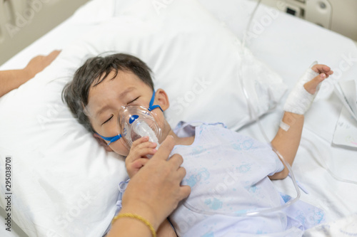 Grandmother take care a kid who is sick flu, He has difficulty breathing Therefore, a doctor giving medicine by a mask.