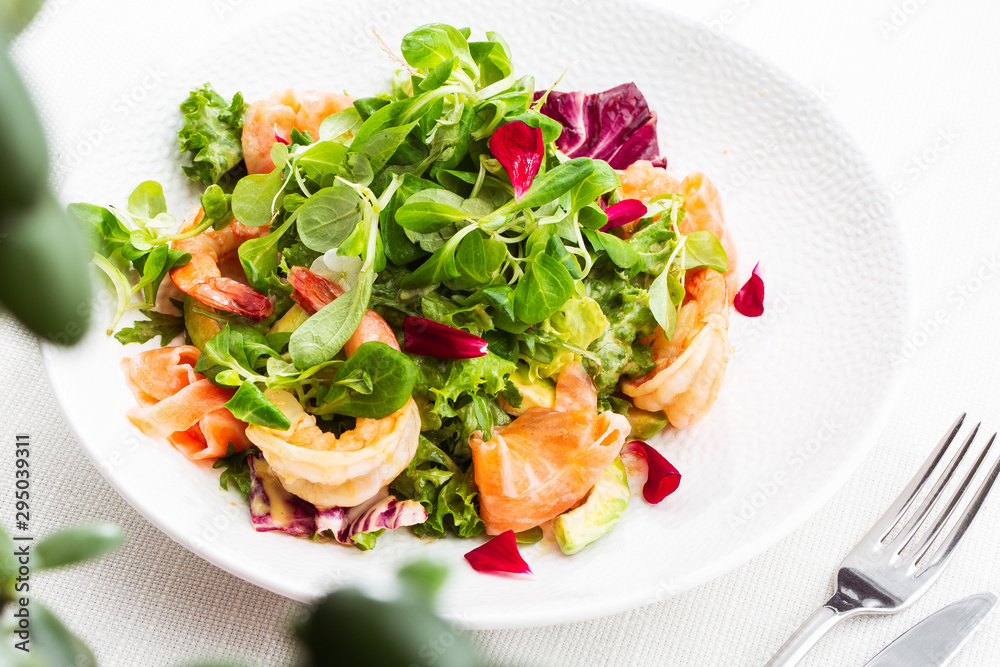 Healthy Salad. Recipe for fresh seafood. Grilled shrimps, prawns, fresh salad lettuce and avocado slices. Healthy Eating. White background. Horizontal photo. Healthy Salad. Recipe for fresh seafood. Grilled shrimps, prawns, fresh salad lettuce and avocado slices. Healthy Eating. White background. Horizontal photo.