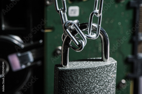 Golden padlock on the opened wallet with money. Protection money concept.Padlock and chain on wooden background. Metal chain and locked padlock on wooden background. Safety concept. photo